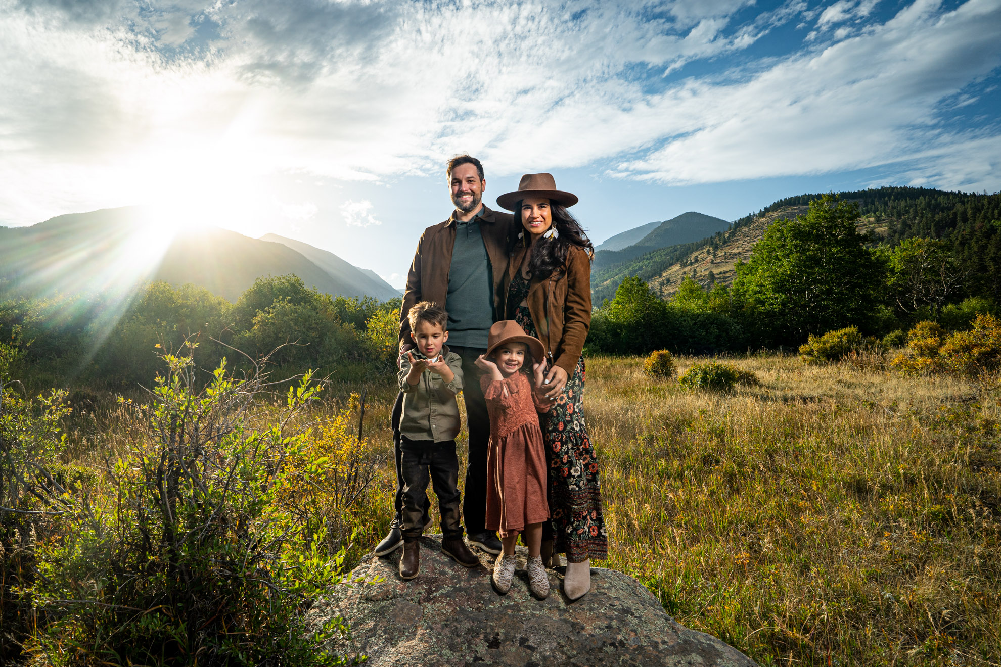 Parents and two kids in an open meadow in Estes Park, Colorado, photographed by Estes Park family photographer, Joe Pyle