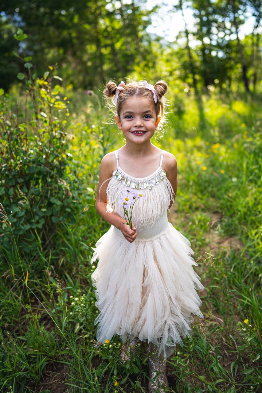 Portrait of girl holding flower, photographed by Estes Park family photographer