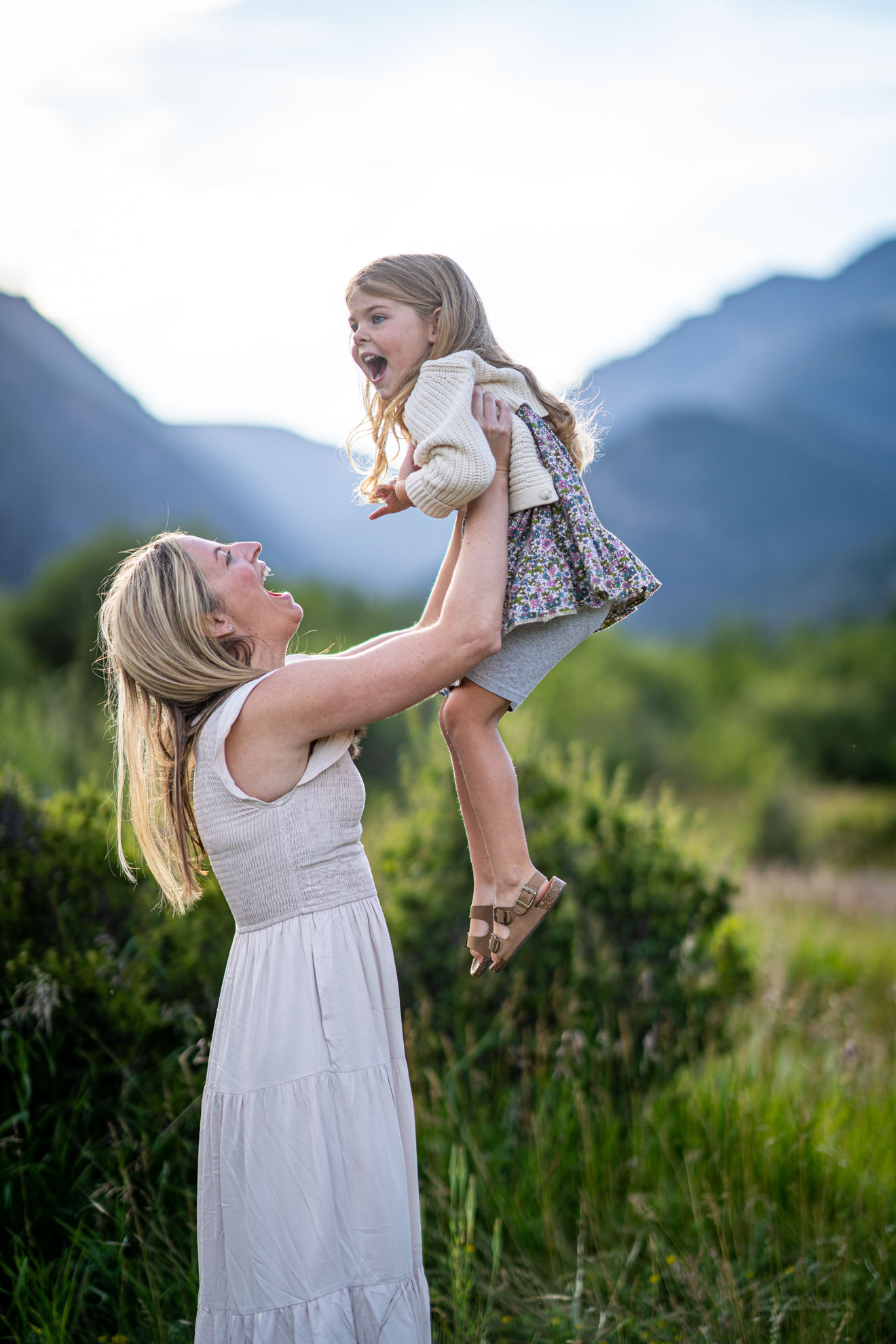 Young mother holds her daughter for a candid picture in Rocky Mountain National Park, photographed by Estes Park family photographer