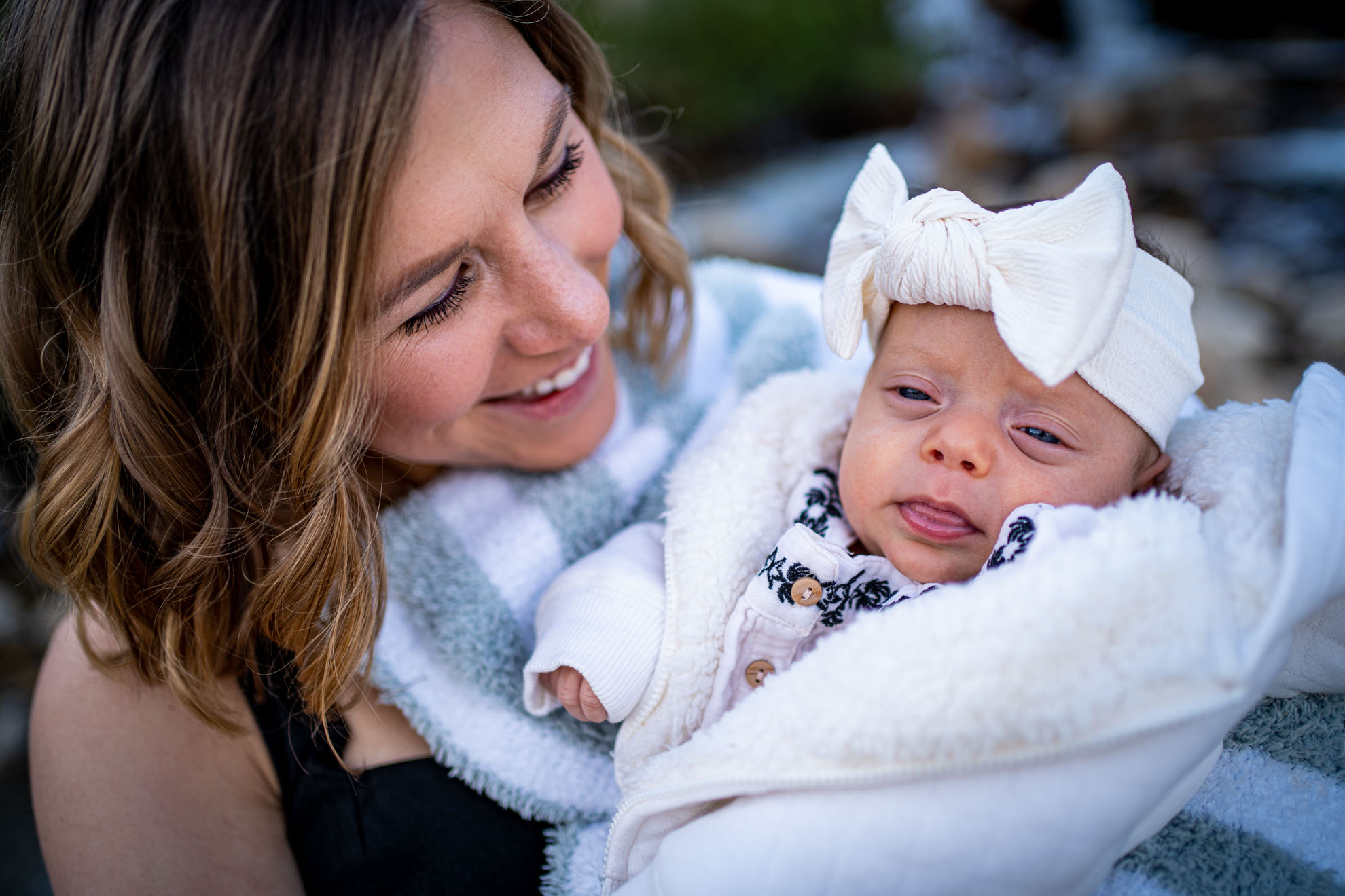 A mother holds her baby for a picture, by Estes Park family photographer